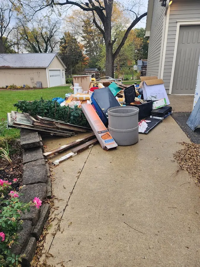 Dumpster being loaded with debris for Estate Cleanout Dumpster Rental in Hanceville